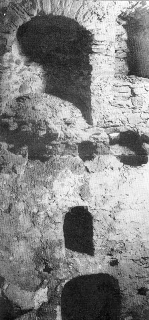 Traces on the outer wall after the great fire of 1833; one can see the places (holes) of the floor beams of a cell, the fireplace, and the window, now walled-up. Under the cell there was a low cellar with a niche and a loophole for firing. Photographer: Prof. Arch. G. Stoykov