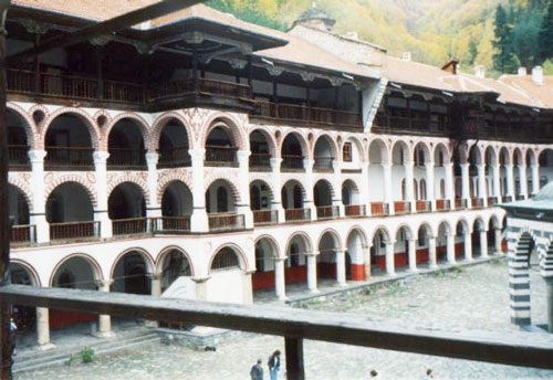Part of the Rila Monastery - the north wing (1817) with a staircase, the kiosk that Krustyu the Debaran built (1834), and a firewall (1834). The great architectural order with and without intermediate arches of the columns can be seen, as well as the cookhouse entrance and dome. Photographer: A. Obretenov