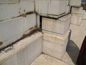 Fig. 14. Subsided and tilted footing blocks with clearly visible gaps several times filled with welded strips. There is also visible total corrosion in some parts of the steel sheet facade panelling